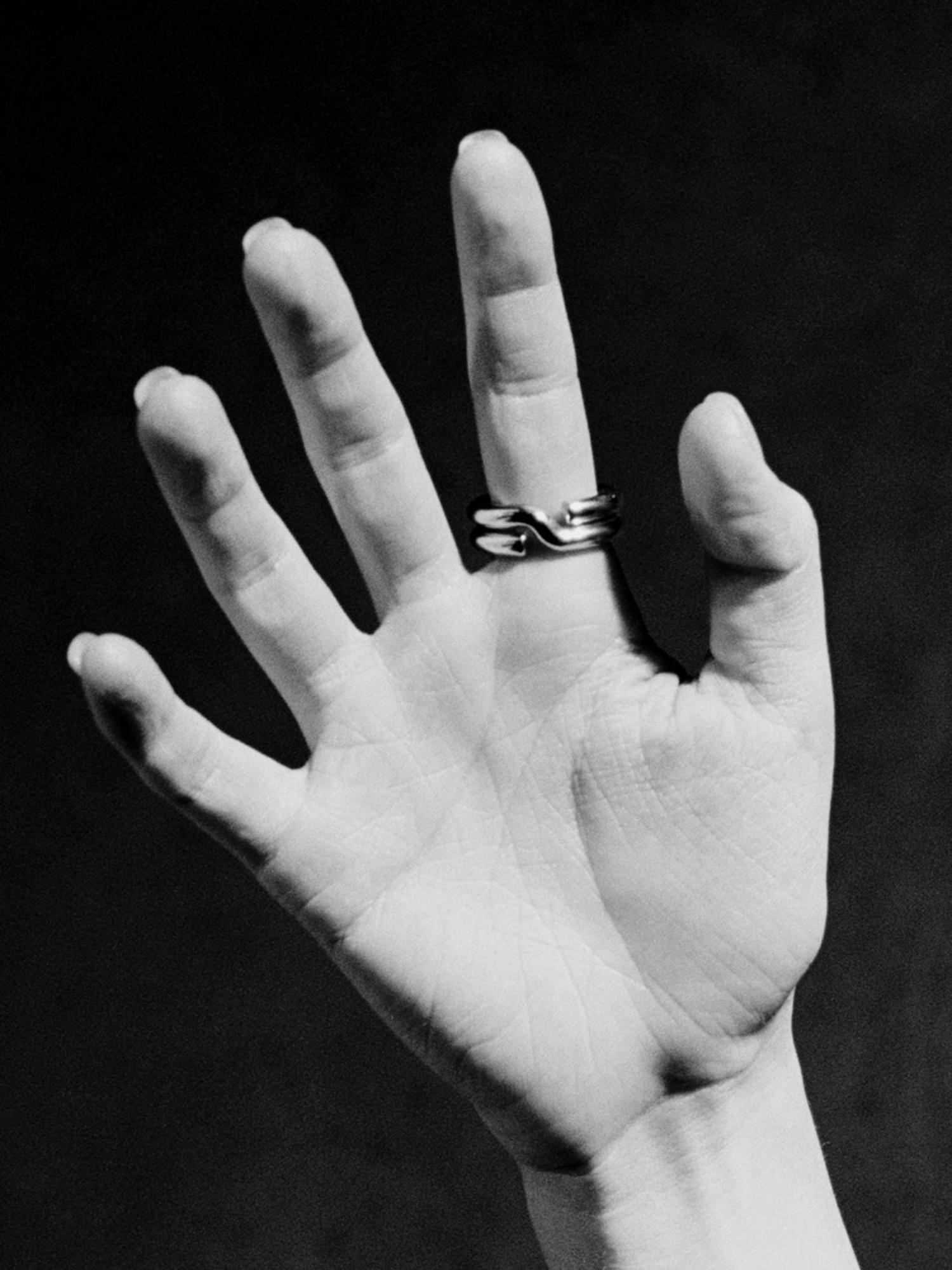 Hand with a ring on a black background